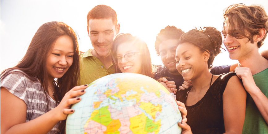 Group of international students hugging globe of the earth