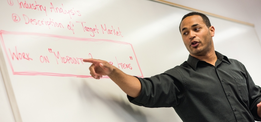 Alumni Keith Obilani teaching in classroom