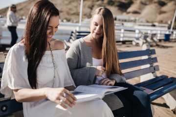 Mini MBA students at the Malibu Pier outside studying together