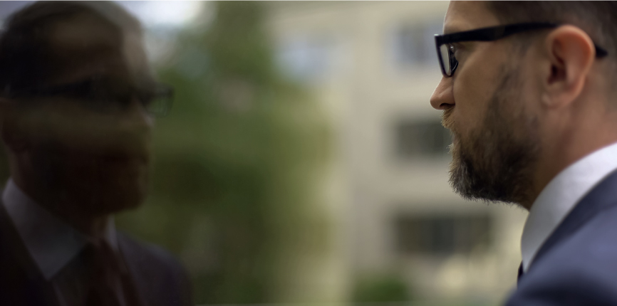 Businessman looking at his reflection