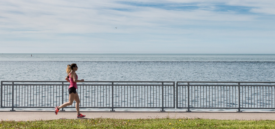 Woman running outside by the beach