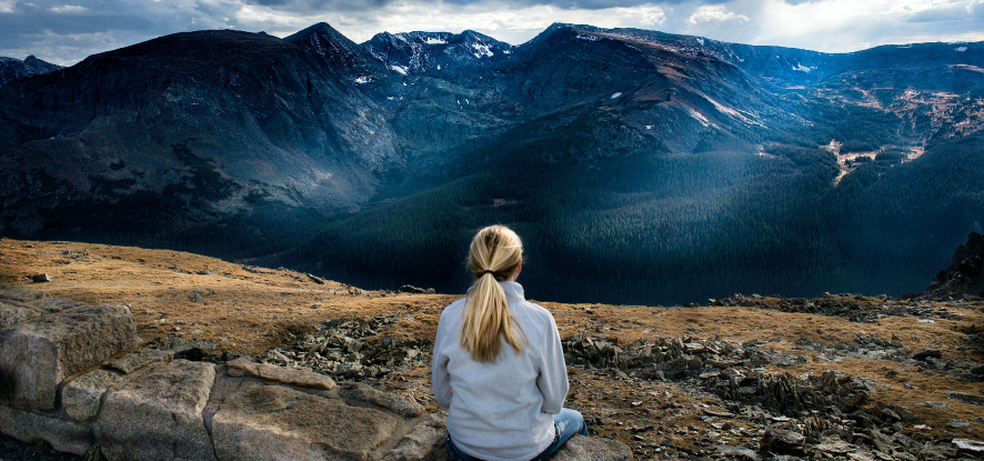 Working professional vacationing and look upon a beautiful mountaion range