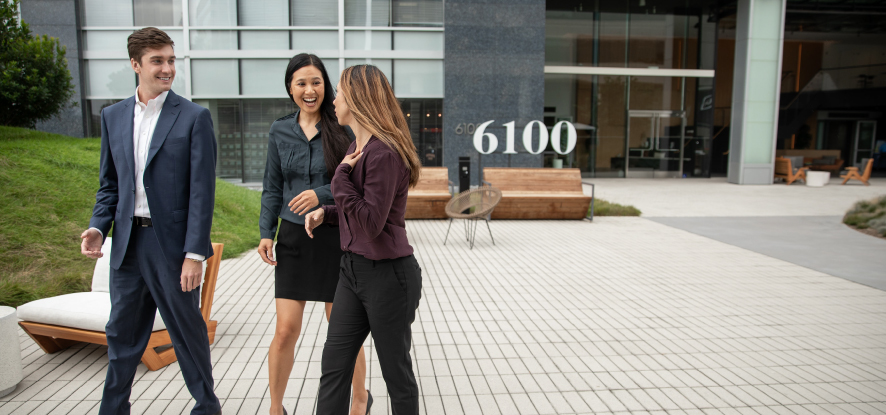 Students networking outside of campus entrance