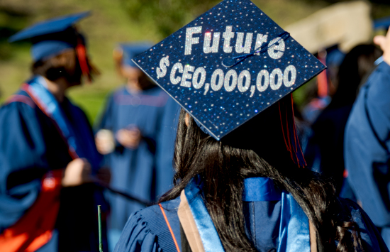 Graduate wearing cap with glitter cheerful message on top