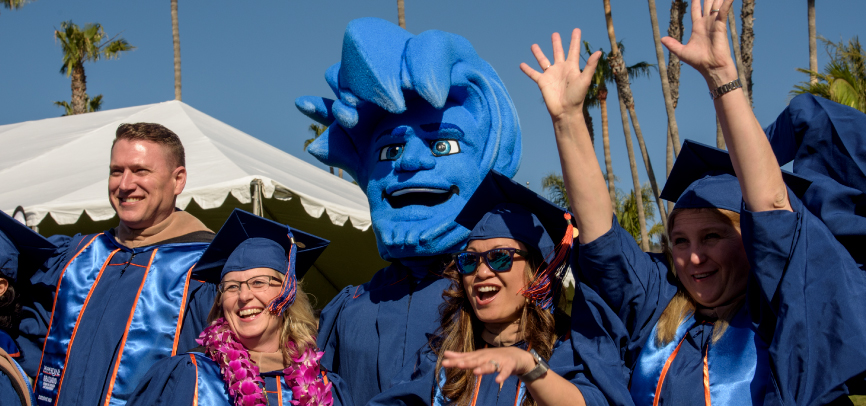 Group of graziadio graduates cheering after ceremony