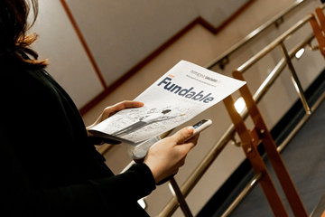 Event attendee holding Most Fundable Companies brochure