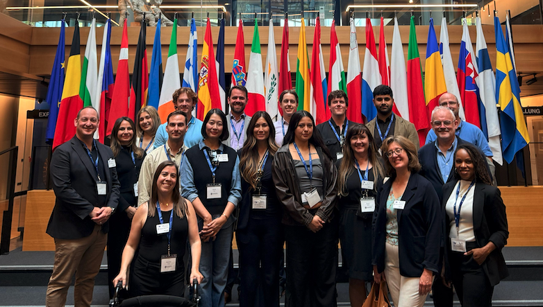 students standing in front of world flags
