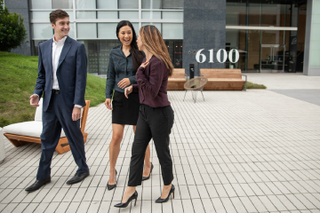 Three students walking outside campus