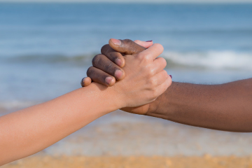 Diversity - people holding hands at beach