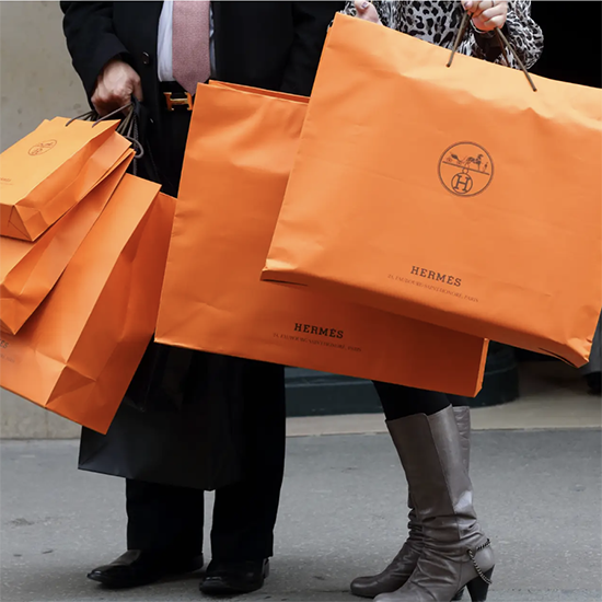 Two people holding Hermes shopping bags REUTERS/Philippe Wojazer