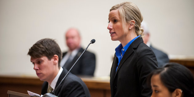 A woman speaks into a microphone at a podium - Pepperdine University